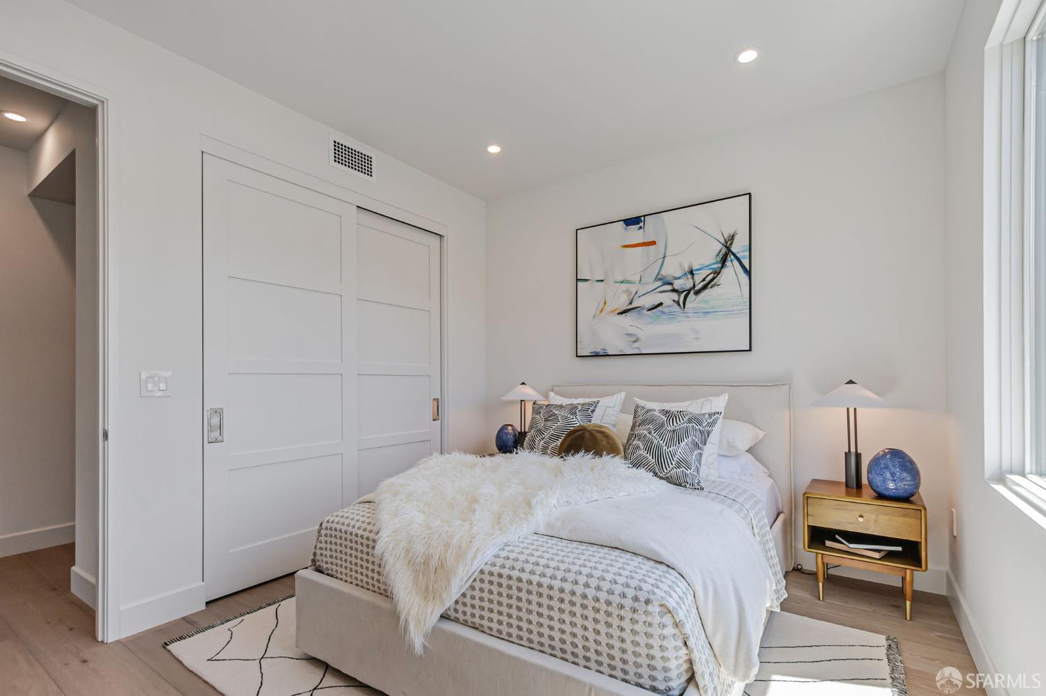 425 1st Street, Unit 21 Los Altos, CA 94022 - Photo 20 of 41 a bedroom with a bed and a painting on the wall