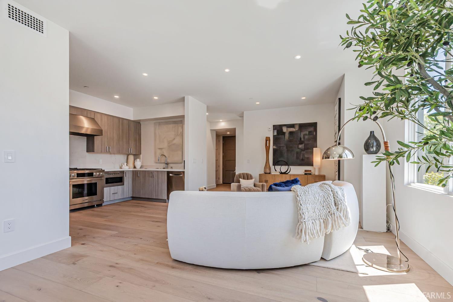 425 1st Street, Unit 21 Los Altos, CA 94022 - Photo 4 of 41 a living room with stainless steel appliances furniture a flat screen tv and a kitchen view