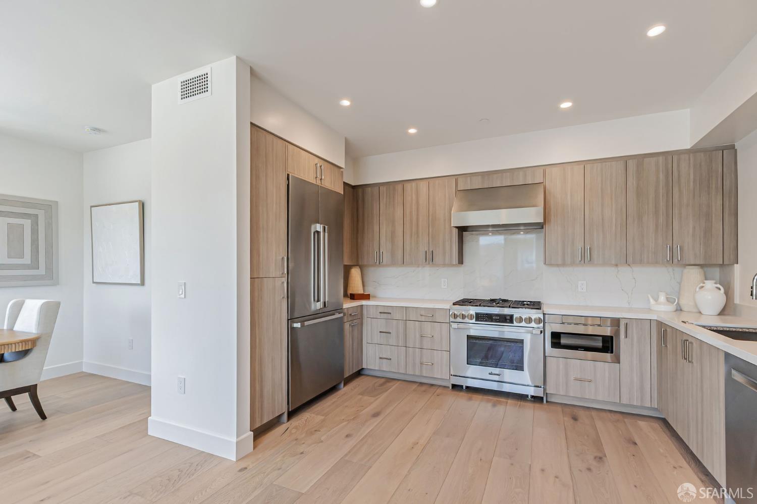 425 1st Street, Unit 21 Los Altos, CA 94022 - Photo 6 of 41 a kitchen with stainless steel appliances granite countertop a stove and a refrigerator