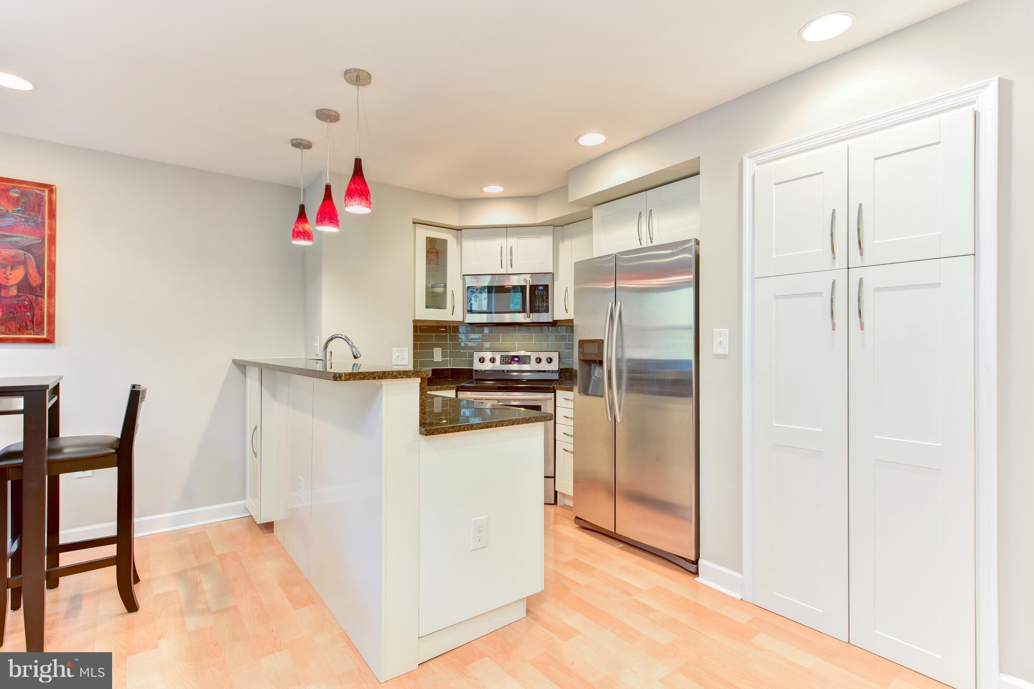 2440 16th Street Northwest, Unit 412 Washington, DC 20009 - Photo 12 of 25 a kitchen with refrigerator and window