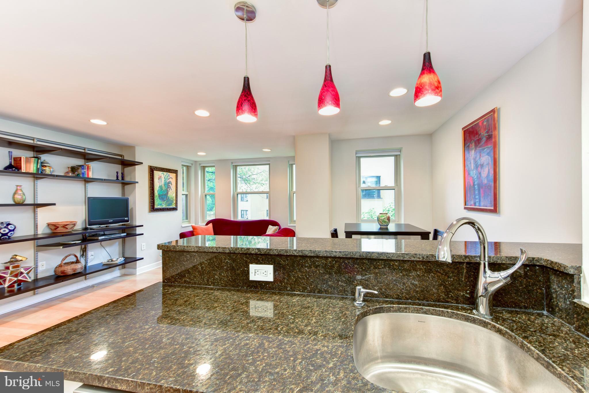 2440 16th Street Northwest, Unit 412 Washington, DC 20009 - Photo 15 of 25 a living room with granite countertop kitchen island a stove and a sink