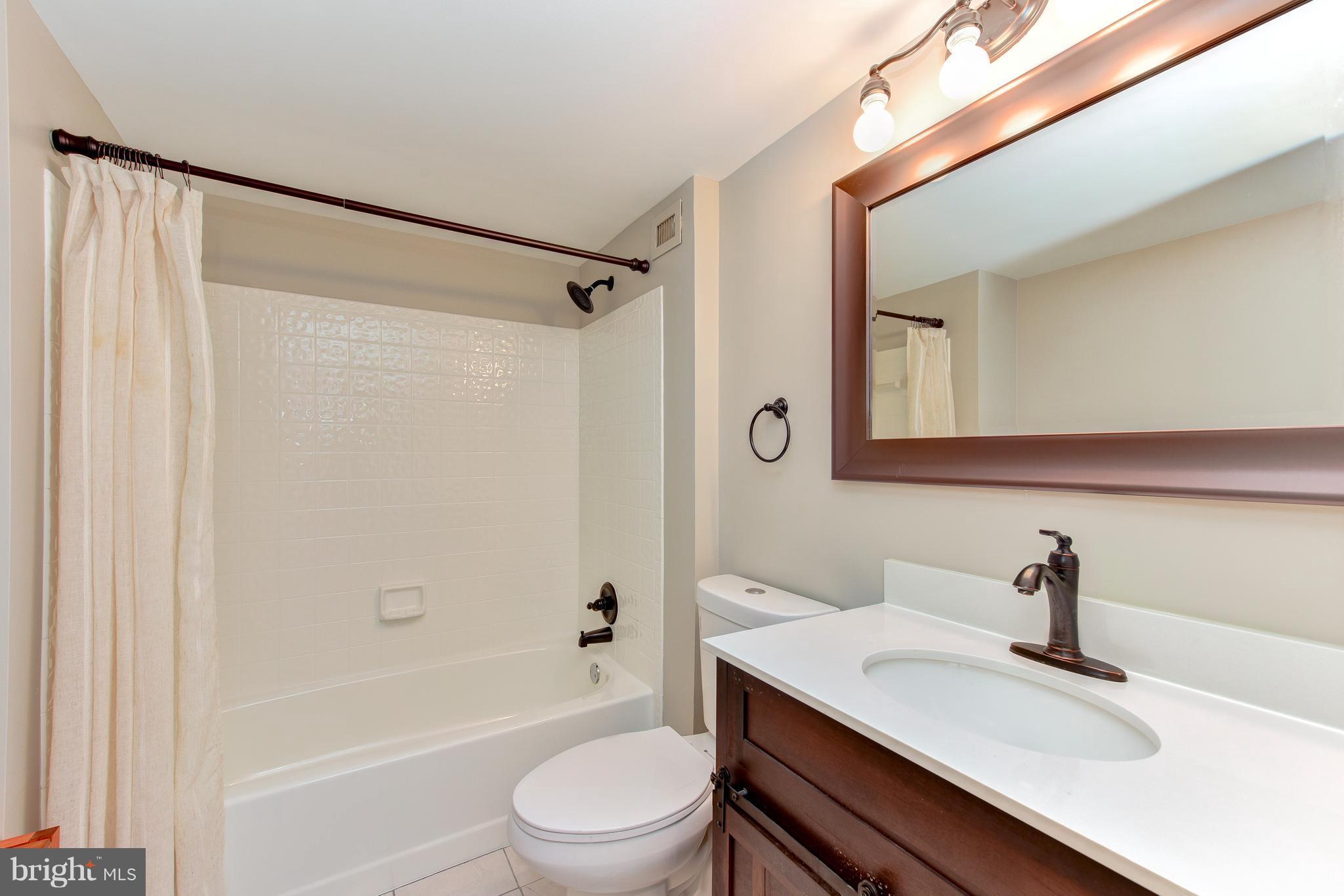 2440 16th Street Northwest, Unit 412 Washington, DC 20009 - Photo 18 of 25 a bathroom with a sink a toilet and shower