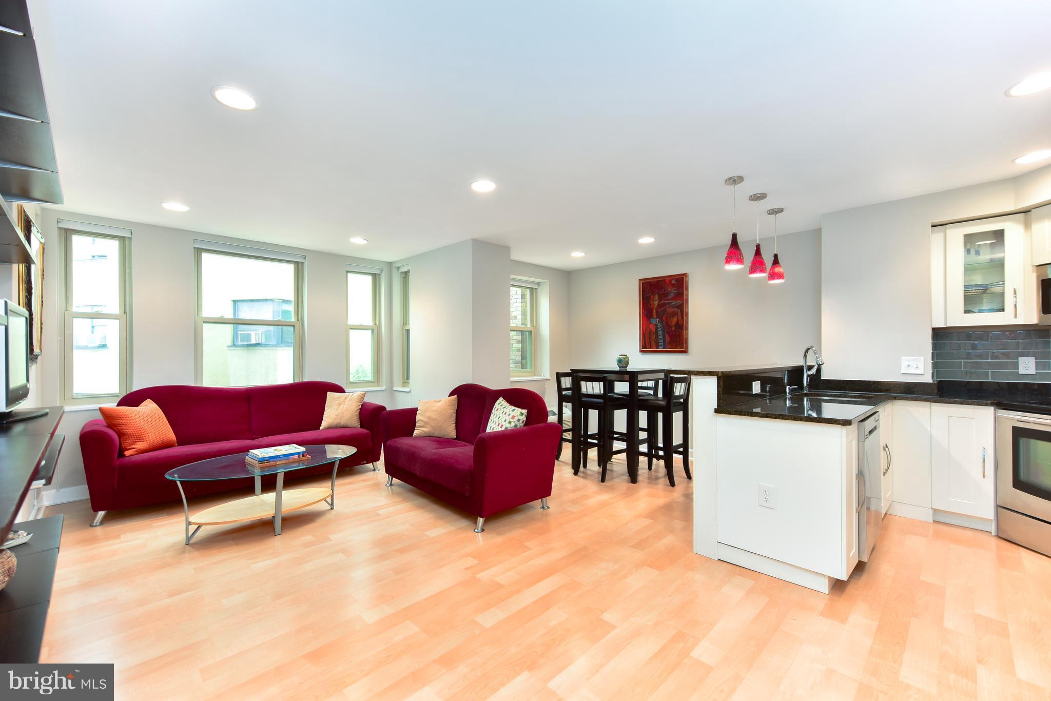 2440 16th Street Northwest, Unit 412 Washington, DC 20009 - Photo 6 of 25 a living room with furniture and kitchen view