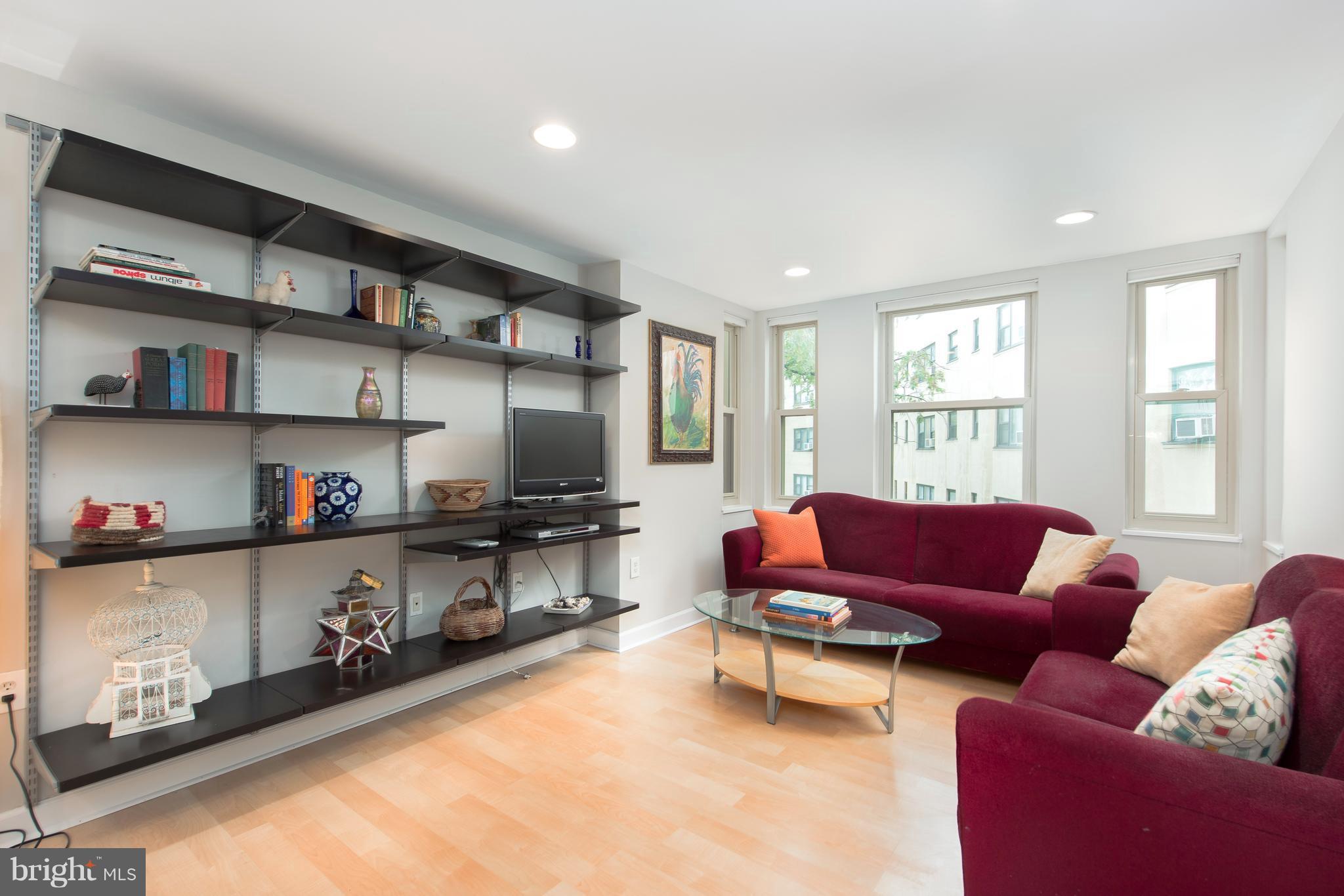 2440 16th Street Northwest, Unit 412 Washington, DC 20009 - Photo 8 of 25 a living room with furniture cabinets and a flat screen tv