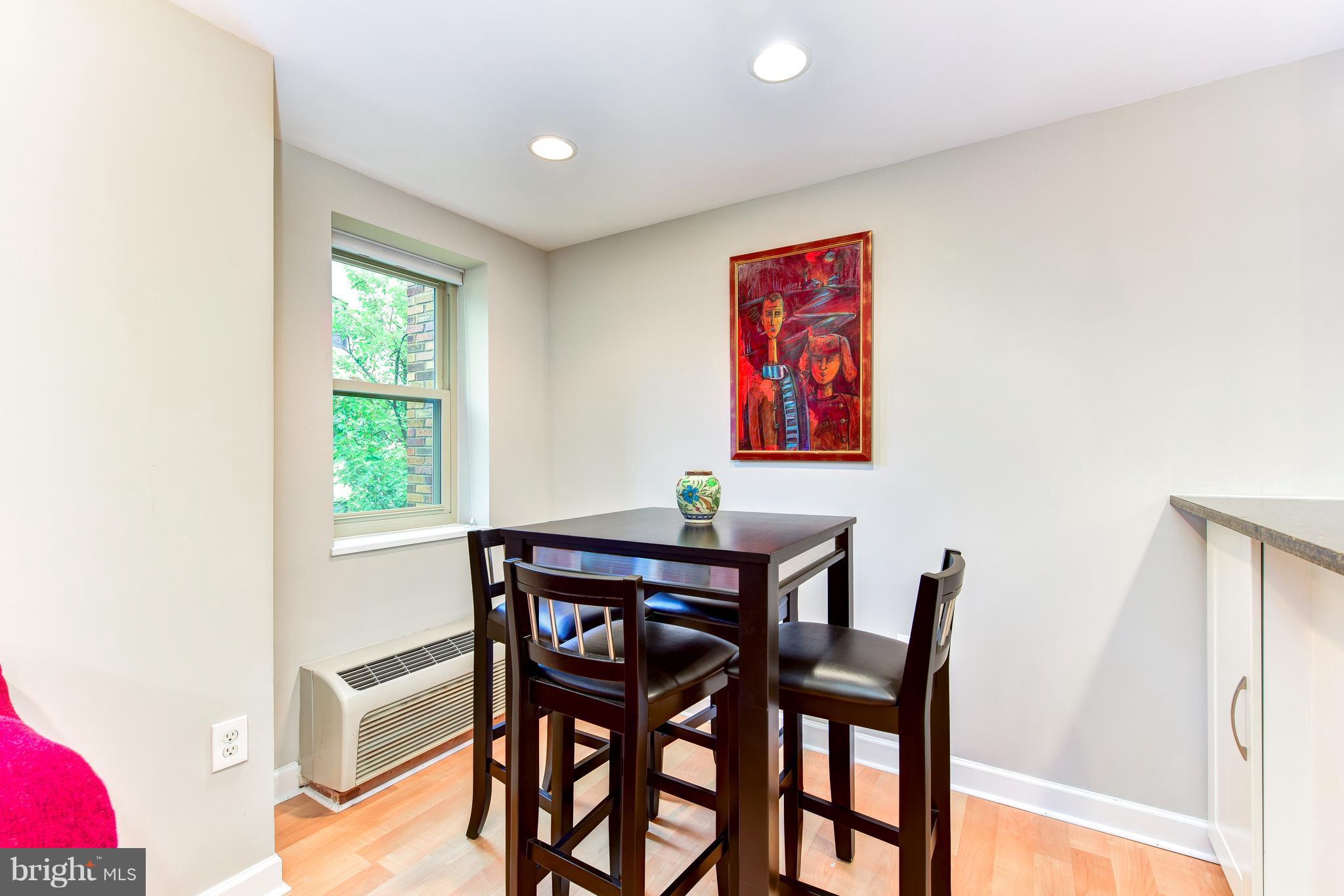 2440 16th Street Northwest, Unit 412 Washington, DC 20009 - Photo 10 of 25 a view of a dining room with furniture window and wooden floor