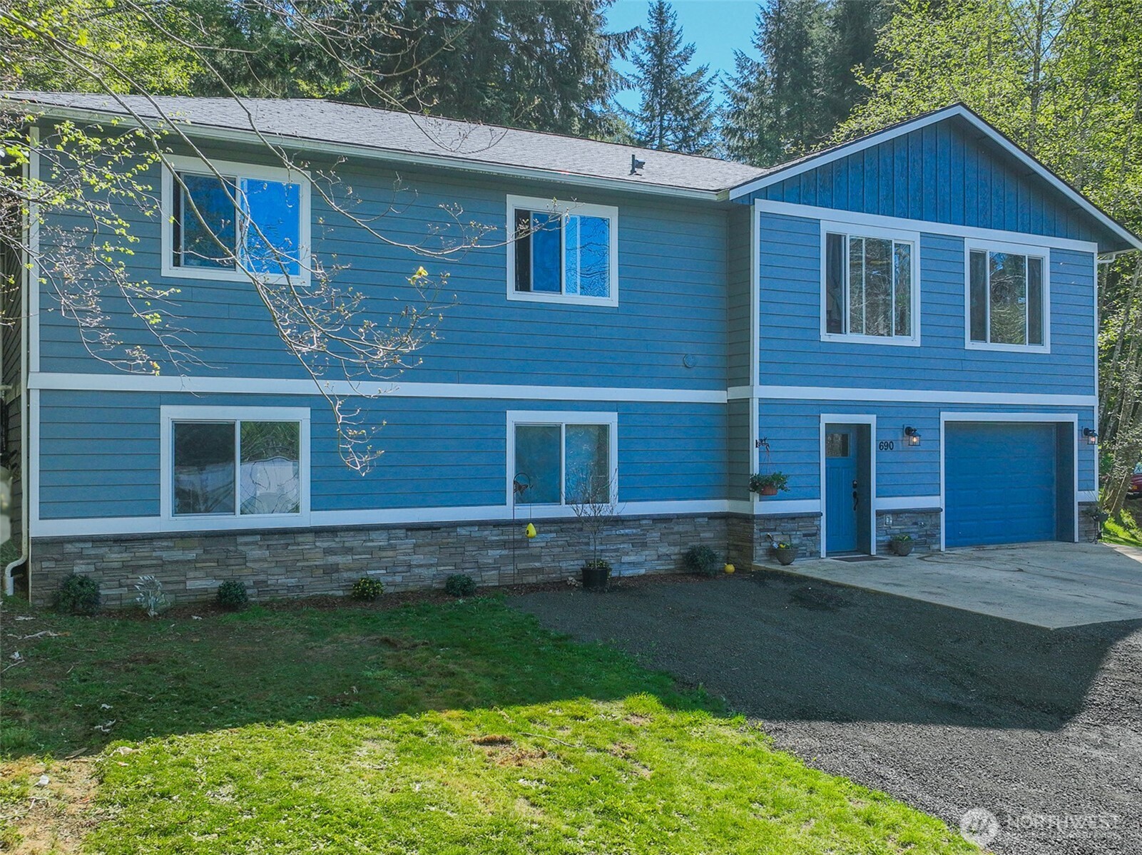 690 North Summit Road McCleary, WA 98557 - Photo 2 of 40 a view of a yard in front of a house with a large window