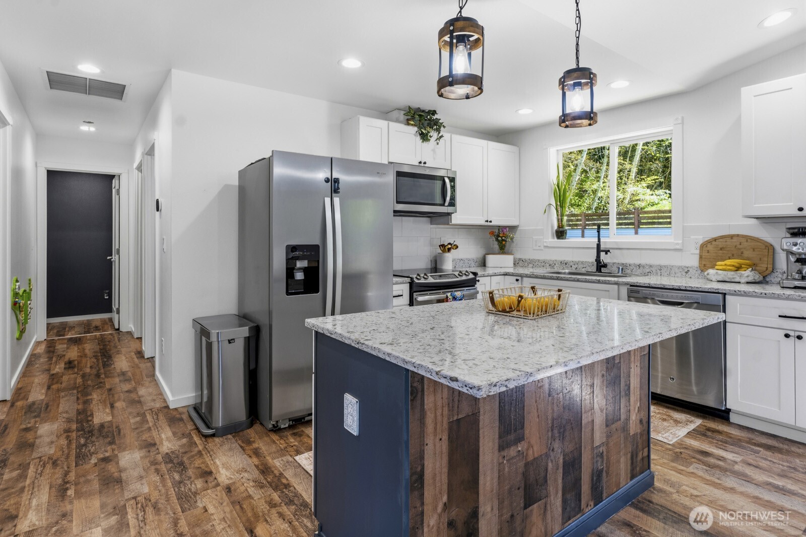 690 North Summit Road McCleary, WA 98557 - Photo 22 of 40 a kitchen with stainless steel appliances granite countertop a sink a stove and a refrigerator