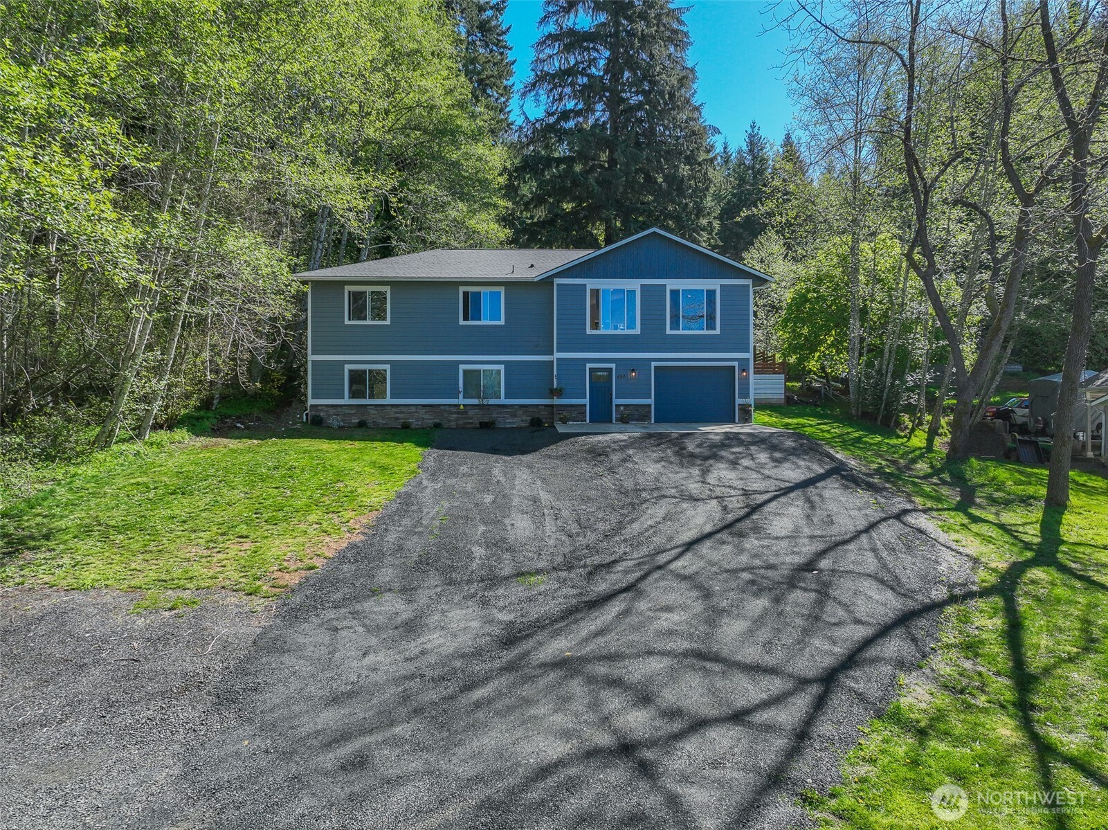 690 North Summit Road McCleary, WA 98557 - Photo 3 of 40 a front view of a house with garden