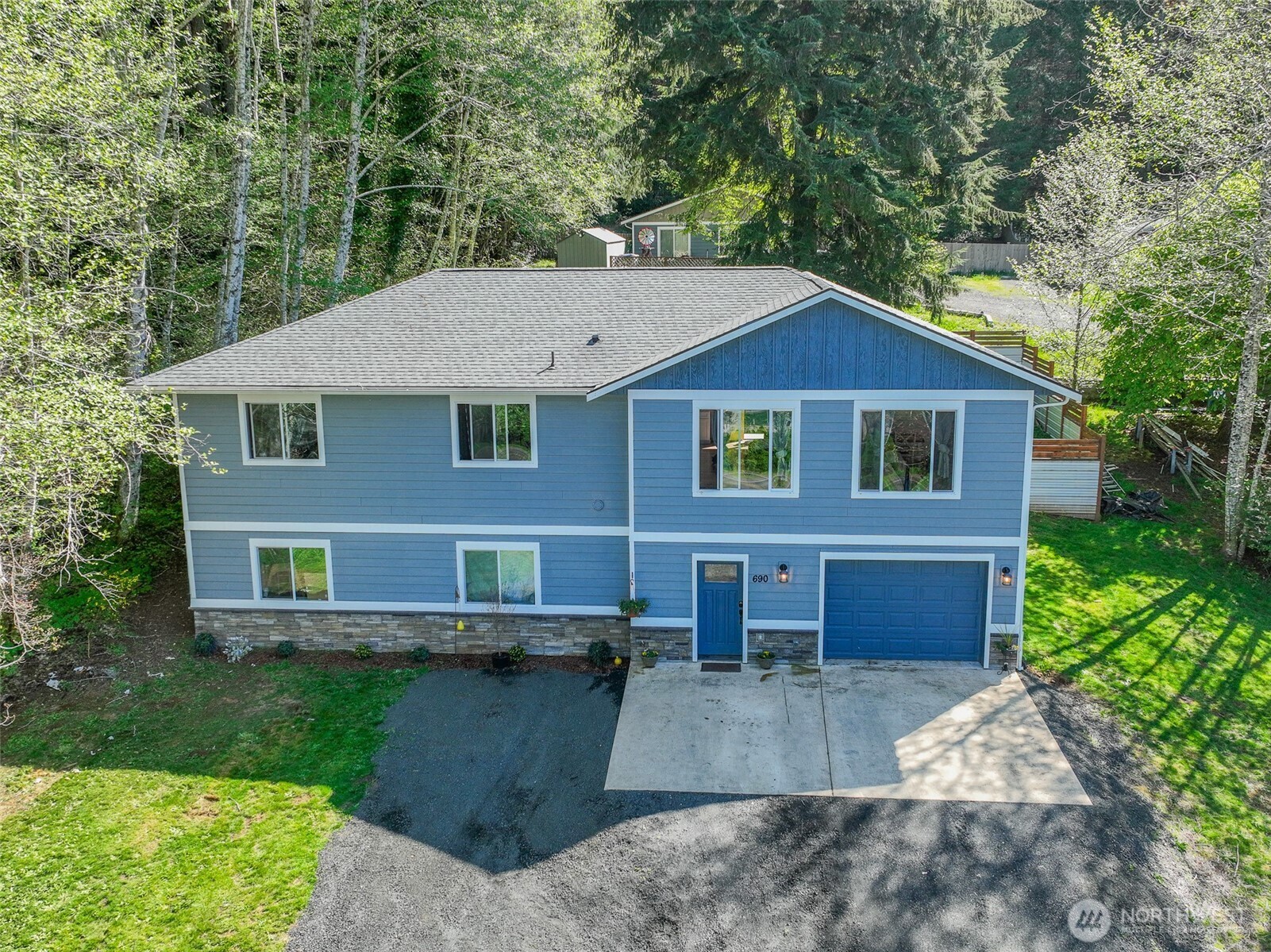 690 North Summit Road McCleary, WA 98557 - Photo 4 of 40 a front view of a house with a garden