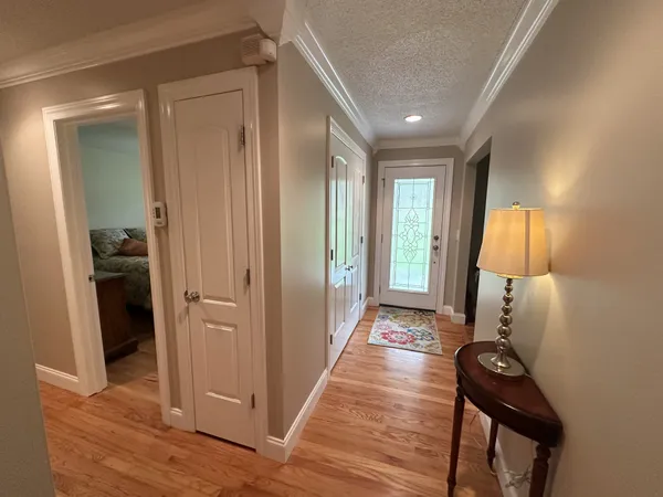 a view of a hallway and a livingroom with furniture