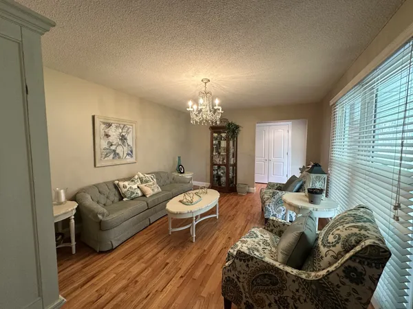 a living room with furniture and a chandelier