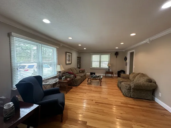 a living room with furniture window and wooden floor