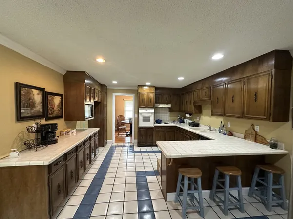 a large kitchen with a table and chairs