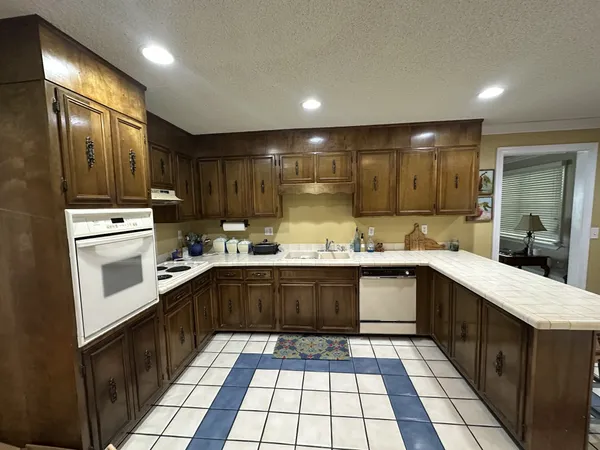 a kitchen with stainless steel appliances granite countertop a sink and cabinets