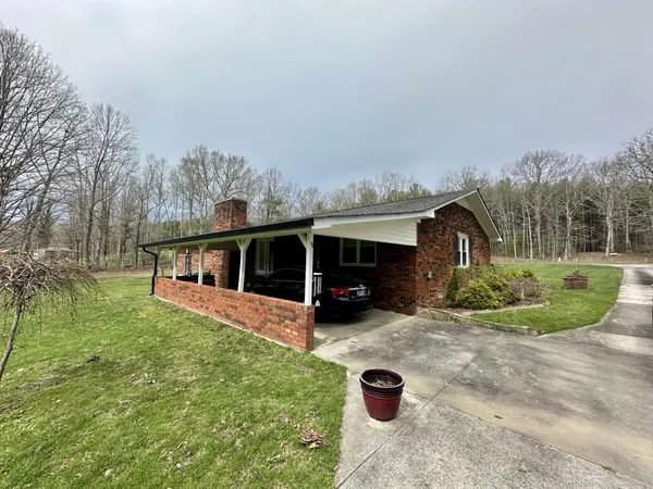 a view of a house with backyard patio and garden