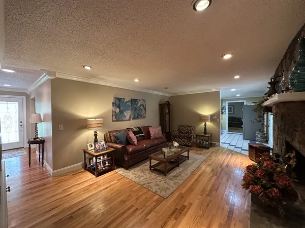 a living room with furniture and a wooden floor
