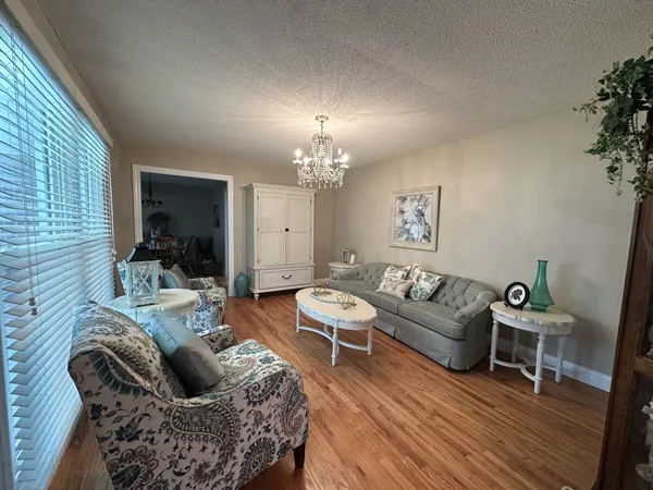 a living room with furniture and a chandelier