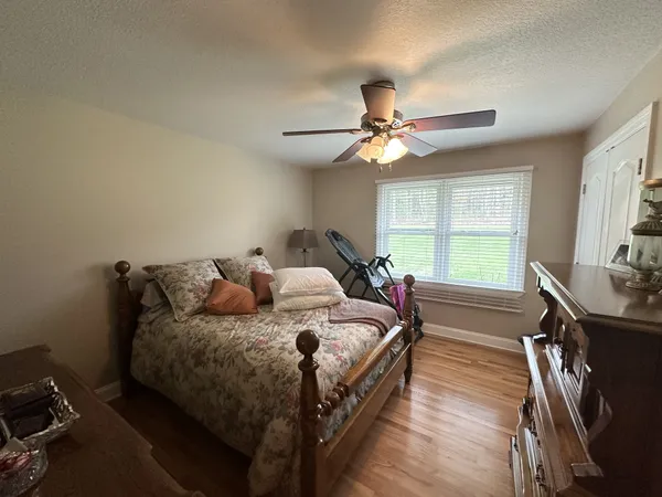 a bed room with a bed window and a ceiling fan