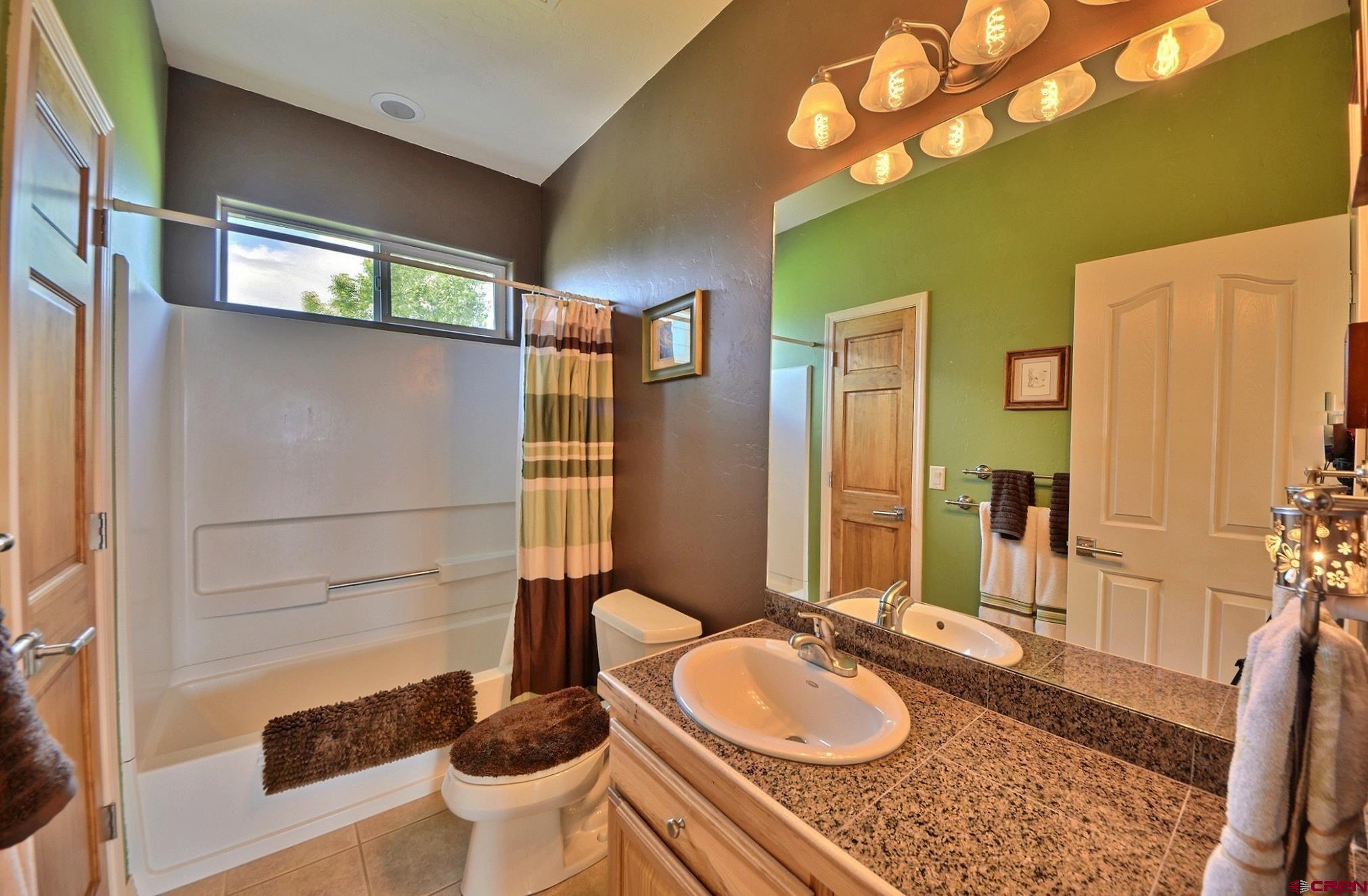 15423 2525th Road Cedaredge, CO 81413 - Photo 17 of 35 a bathroom with a granite countertop sink and a mirror