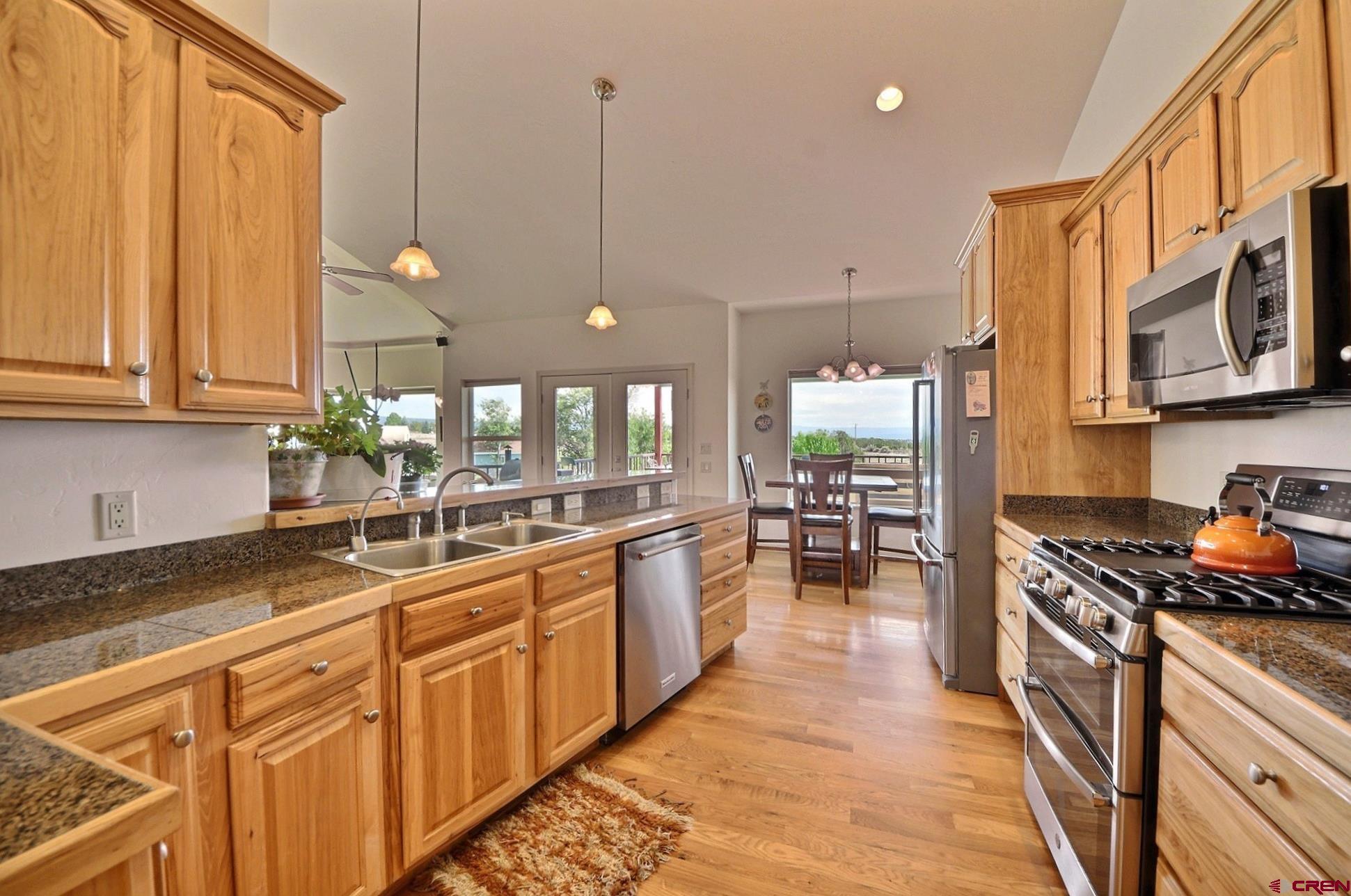 15423 2525th Road Cedaredge, CO 81413 - Photo 10 of 35 a kitchen with stainless steel appliances granite countertop a stove a sink and a microwave