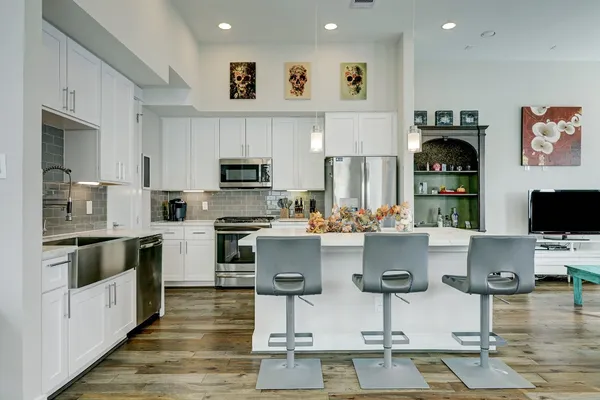 a kitchen with stainless steel appliances granite countertop a stove and cabinets