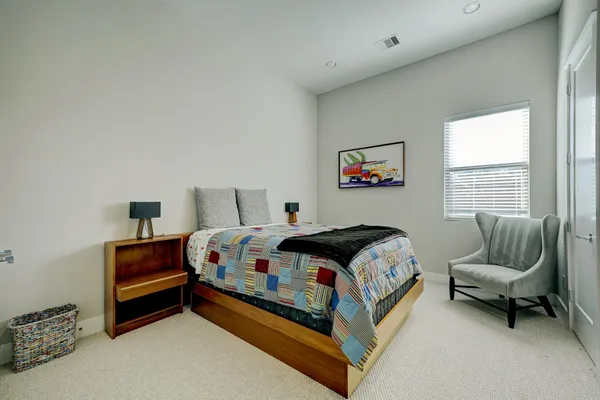 a bedroom with a bed and a couch