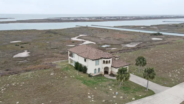 a view of a house with a yard and ocean view