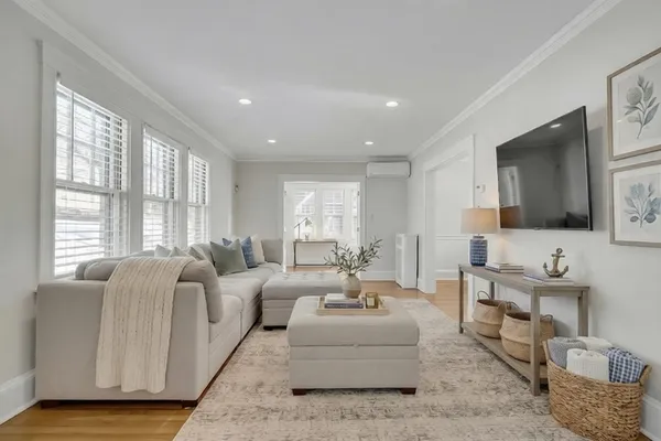 a living room with furniture wooden floor and a flat screen tv