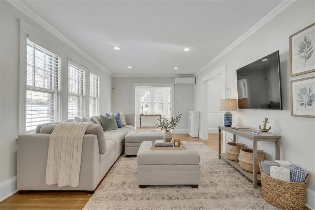 a living room with furniture wooden floor and a flat screen tv