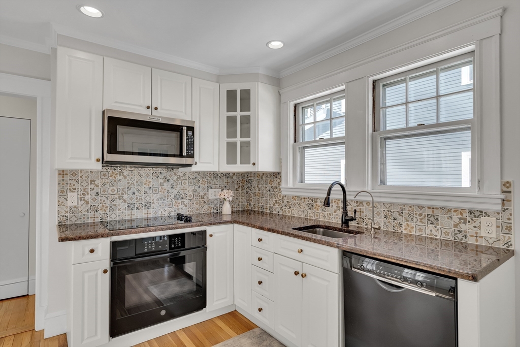 10 Dexter Road Lexington, MA 02420 - Photo 13 of 30 a kitchen with granite countertop a sink stove and microwave