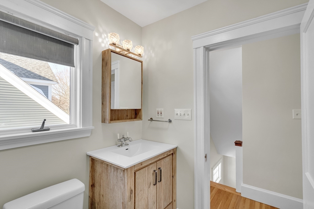 10 Dexter Road Lexington, MA 02420 - Photo 22 of 30 a bathroom with a sink a toilet and a mirror