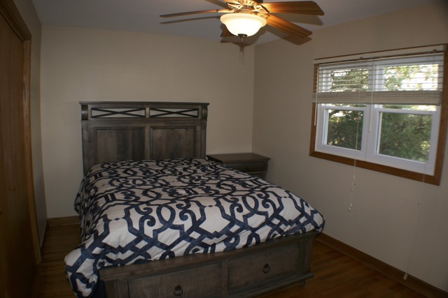 933 Wisconsin Road New Lenox, IL 60451 - Photo 12 of 16 a bedroom with a bed and a window