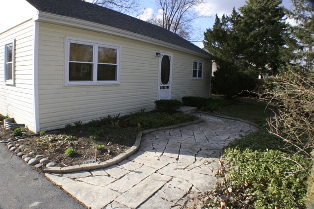 933 Wisconsin Road New Lenox, IL 60451 - Photo 3 of 16 a view of a backyard with potted plants