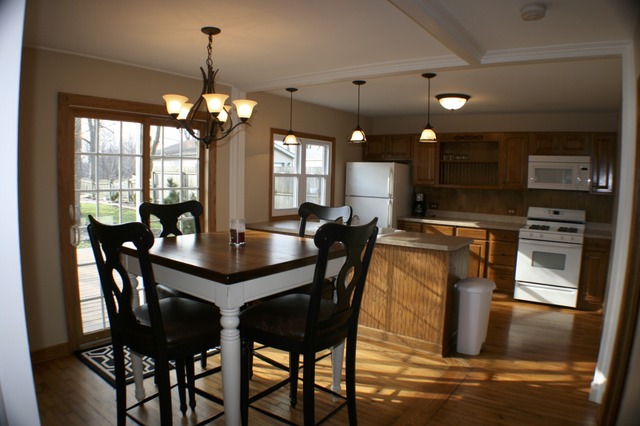 933 Wisconsin Road New Lenox, IL 60451 - Photo 7 of 16 a kitchen with stainless steel appliances granite countertop a table chairs stove and refrigerator