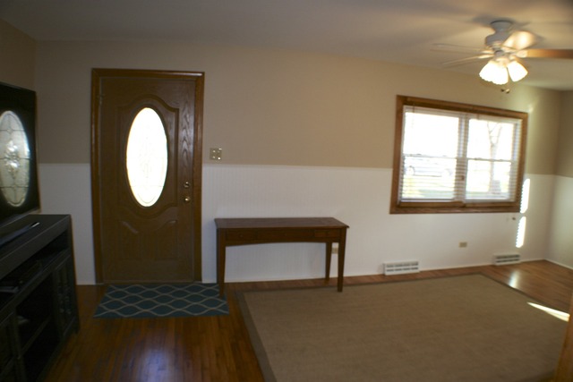 933 Wisconsin Road New Lenox, IL 60451 - Photo 10 of 16 a living room with furniture and a fireplace