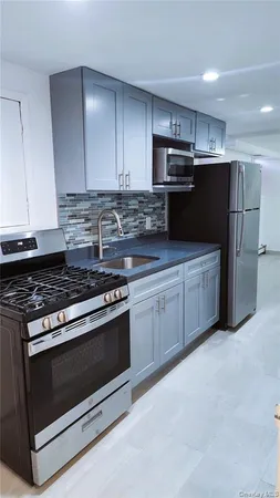 a kitchen with stainless steel appliances granite countertop a stove and a refrigerator