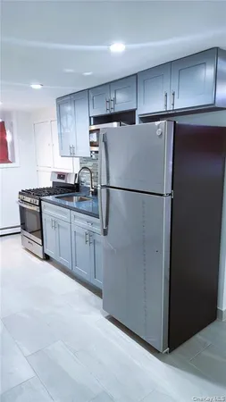 a white refrigerator freezer sitting in a kitchen