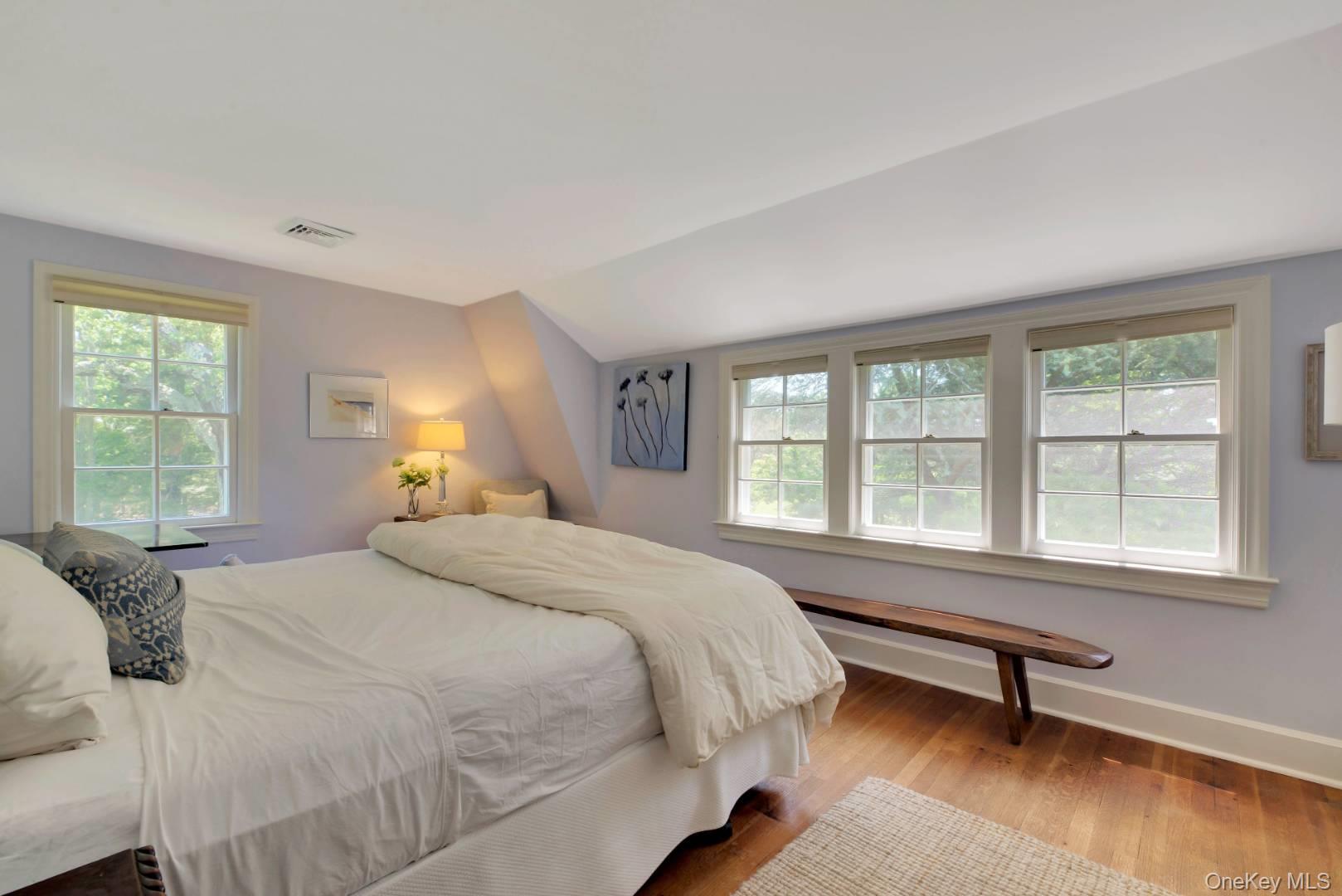 90 Old Depot Road Quogue, NY 11959 - Photo 11 of 21 a spacious bedroom with a bed a chair and next to a window