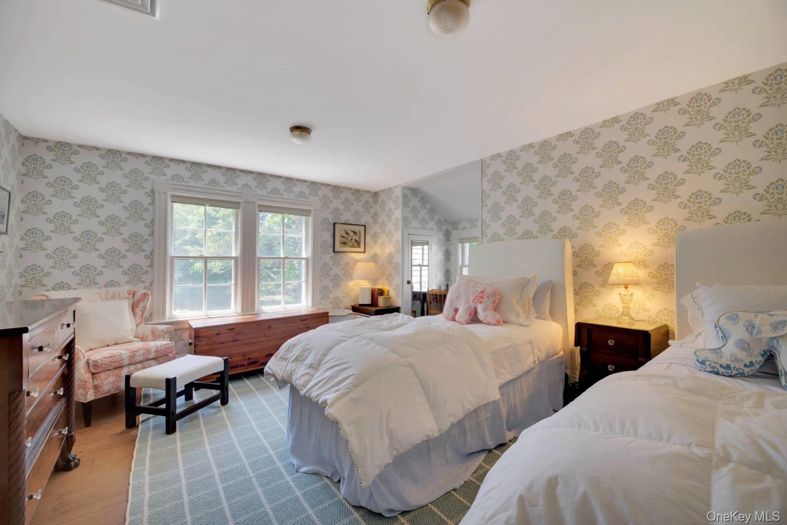 90 Old Depot Road Quogue, NY 11959 - Photo 13 of 21 a bedroom with two beds and a large window