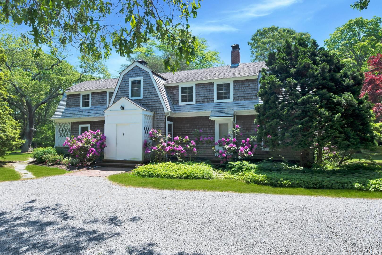 90 Old Depot Road Quogue, NY 11959 - Photo 16 of 21 a front view of a house with a yard and garage