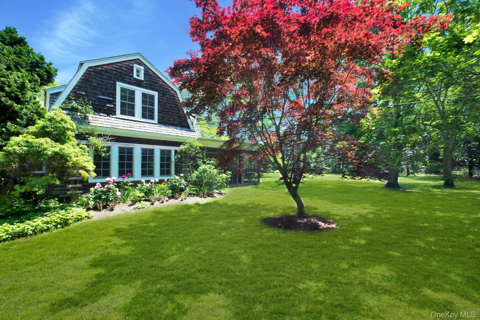 90 Old Depot Road Quogue, NY 11959 - Photo 17 of 21 a front view of a house with a yard