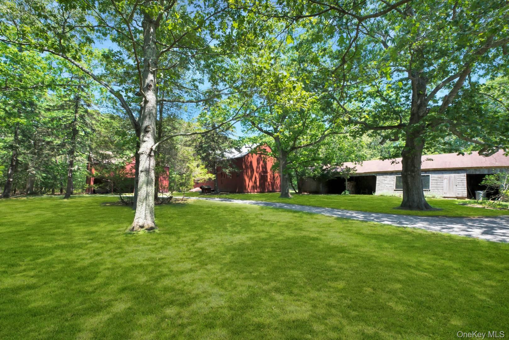 90 Old Depot Road Quogue, NY 11959 - Photo 20 of 21 a view of a backyard with a garden and trees