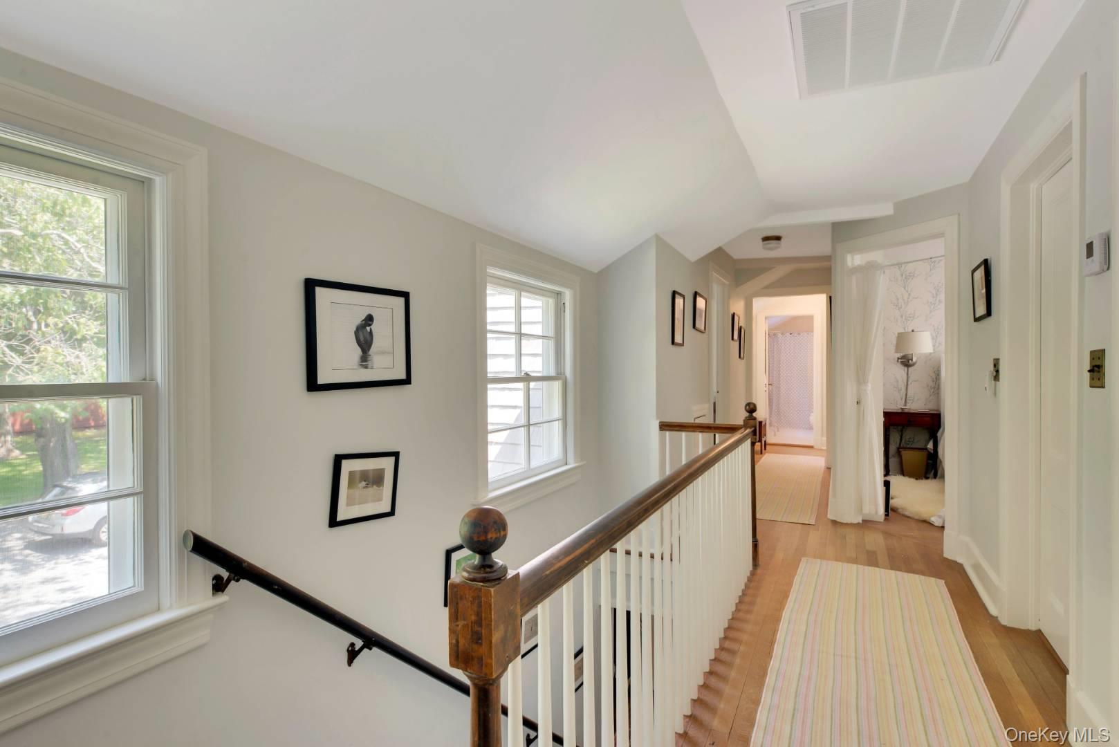 90 Old Depot Road Quogue, NY 11959 - Photo 10 of 21 a view of a hallway with windows and stairs