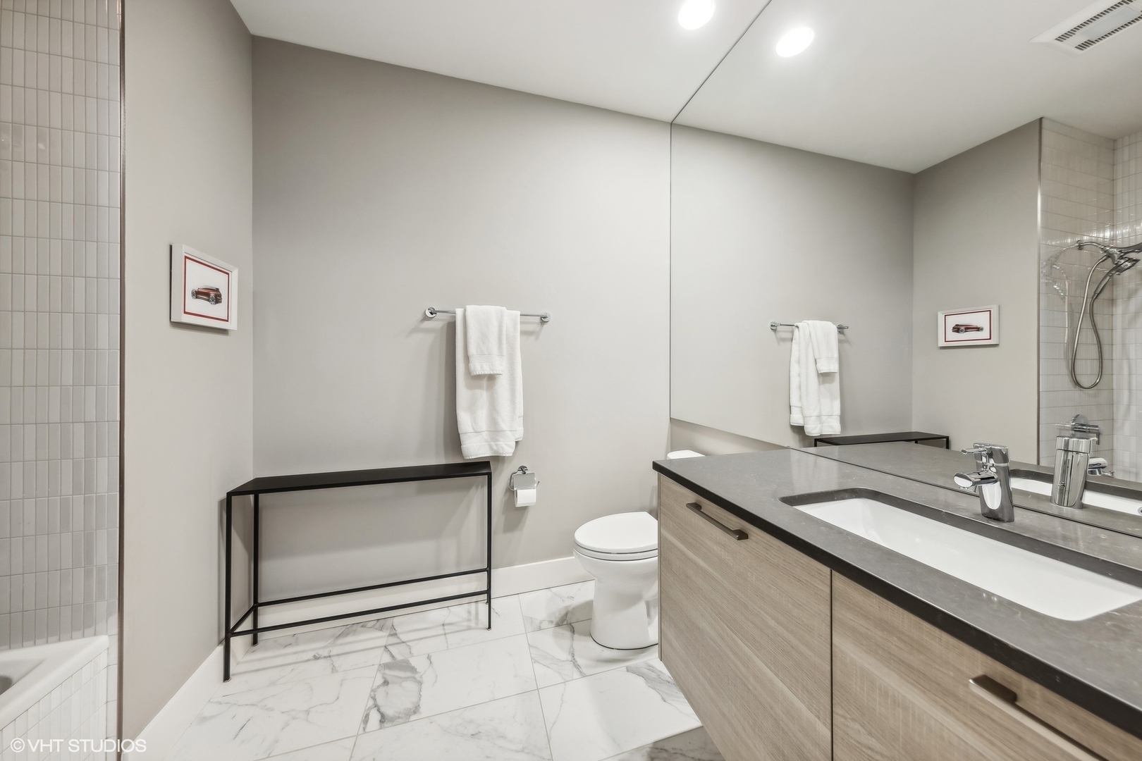 1128 West Adams Street, Unit 4E Chicago, IL 60607 - Photo 15 of 21 a bathroom with a granite countertop sink a toilet and a mirror