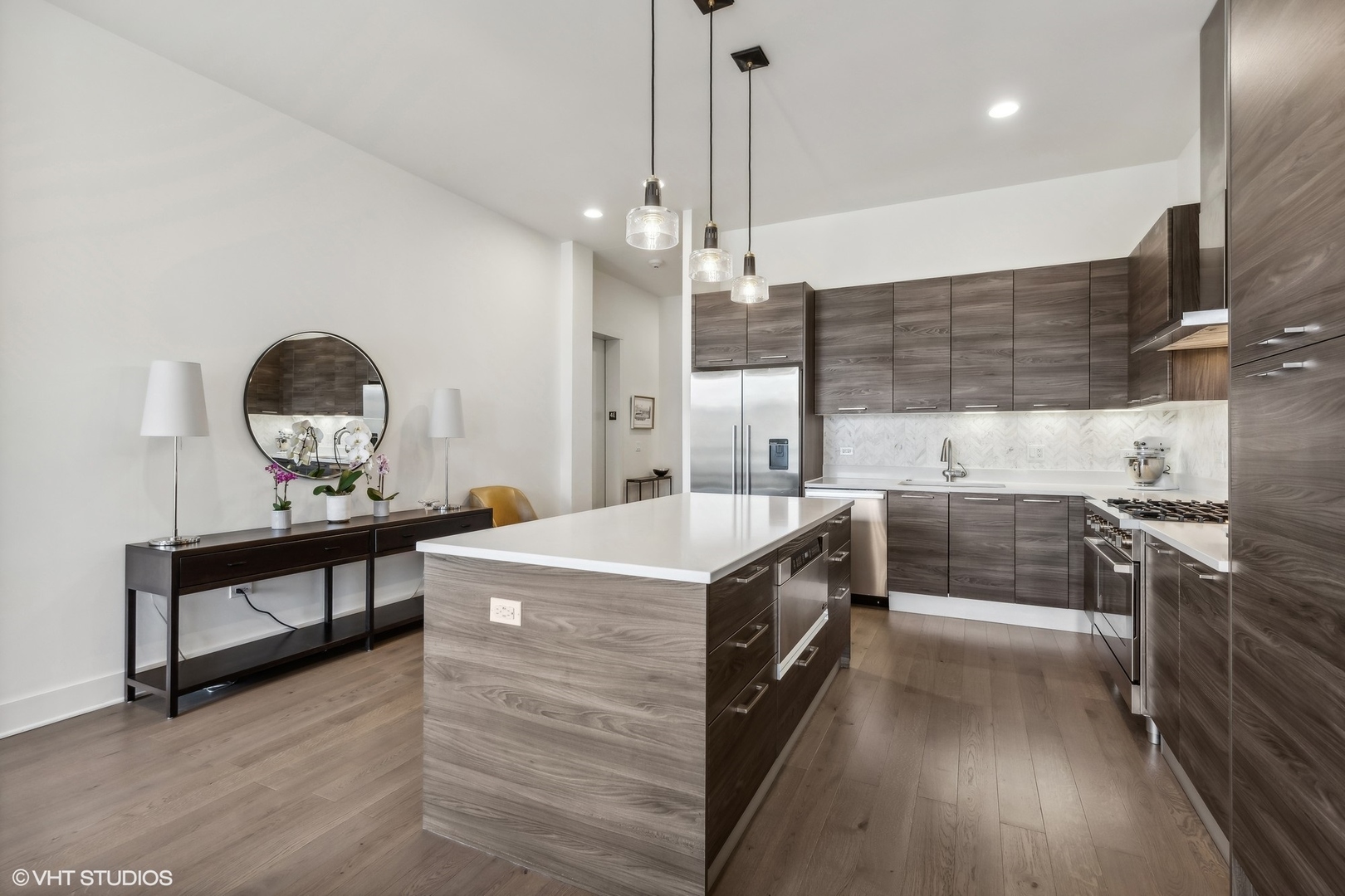 1128 West Adams Street, Unit 4E Chicago, IL 60607 - Photo 18 of 21 a kitchen with stainless steel appliances granite countertop a stove and a wooden floors