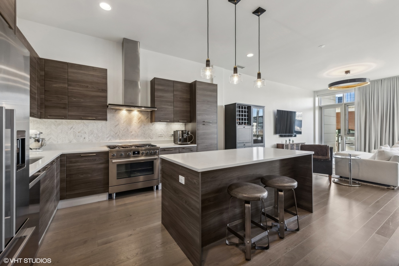 1128 West Adams Street, Unit 4E Chicago, IL 60607 - Photo 3 of 21 a kitchen with kitchen island white cabinets and stainless steel appliances