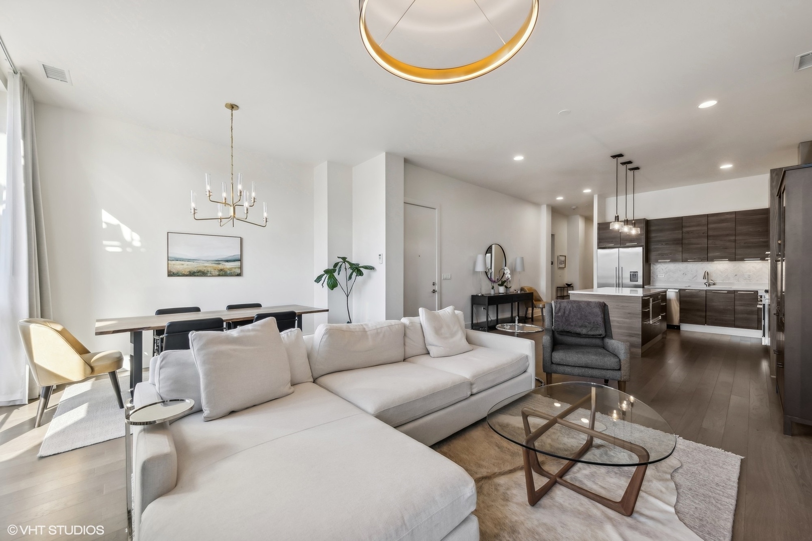 1128 West Adams Street, Unit 4E Chicago, IL 60607 - Photo 5 of 21 a living room with furniture and a chandelier
