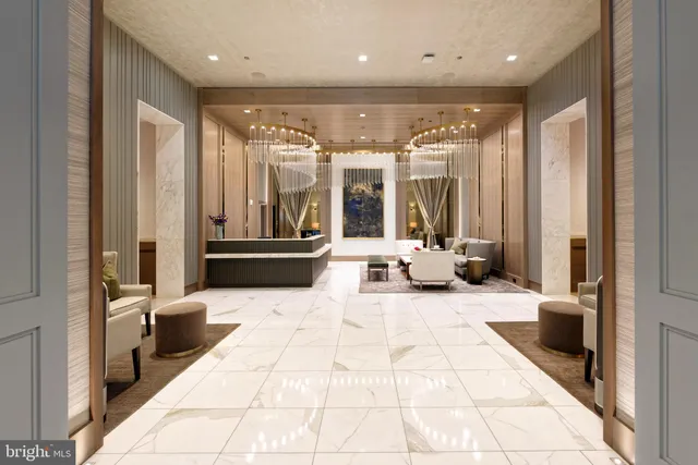 a lobby with furniture and large windows