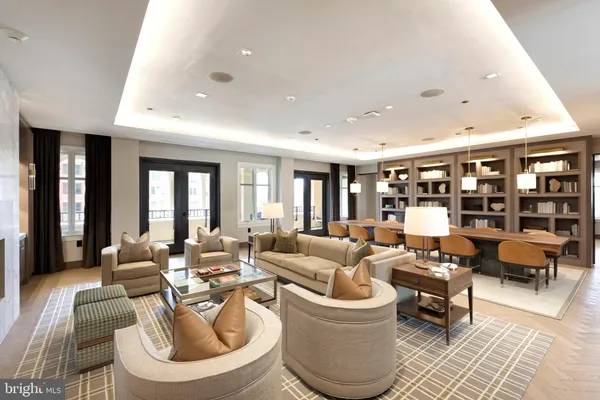 a dining hall with stainless steel appliances granite countertop table chairs and a kitchen view