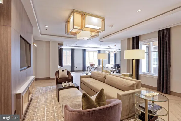 a living room with furniture and large windows